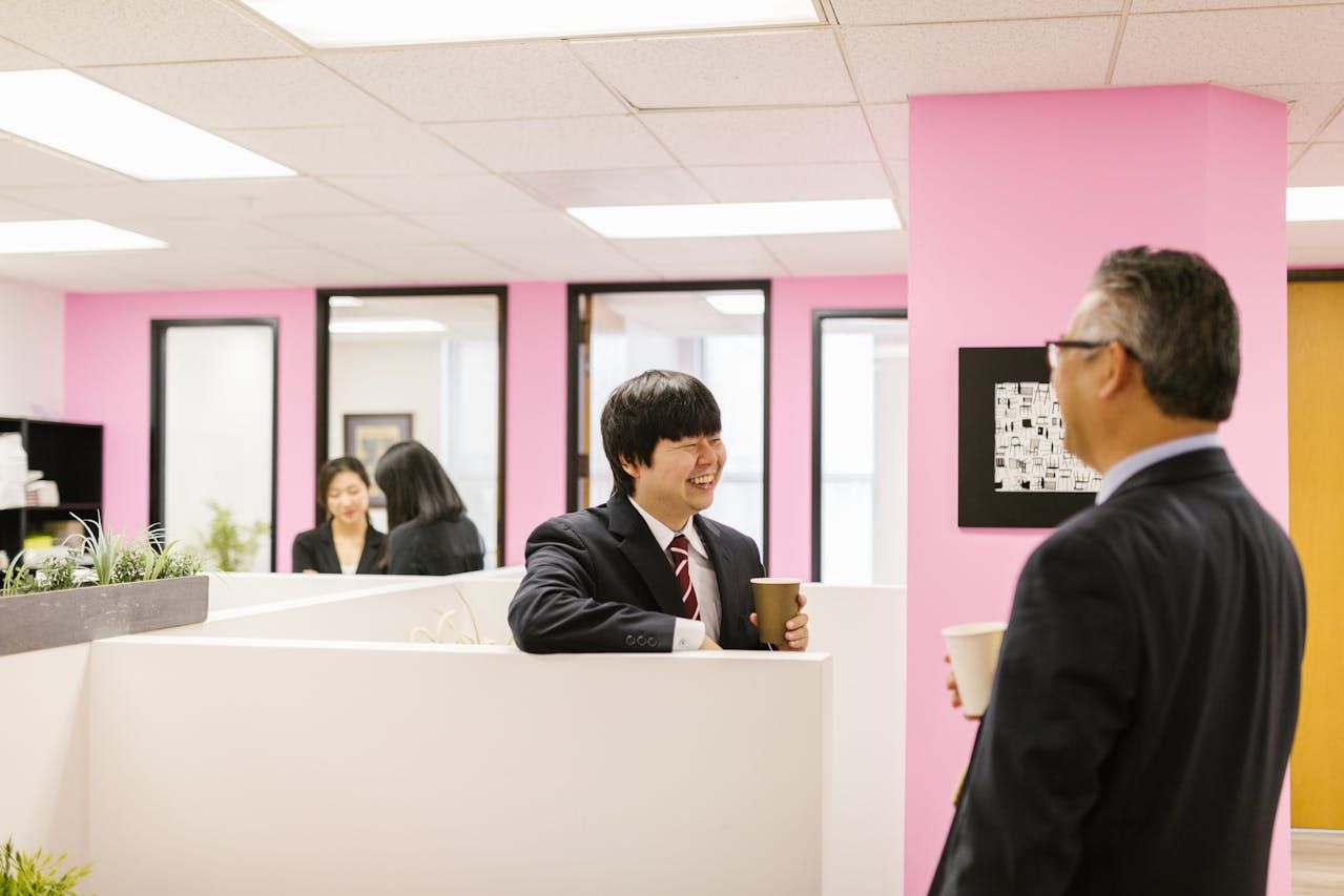 Two people talking in a colorful modern office space