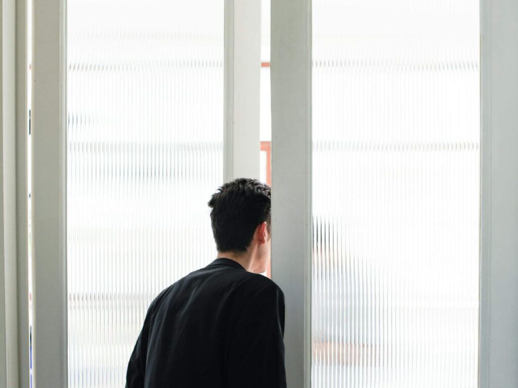Man looking out door