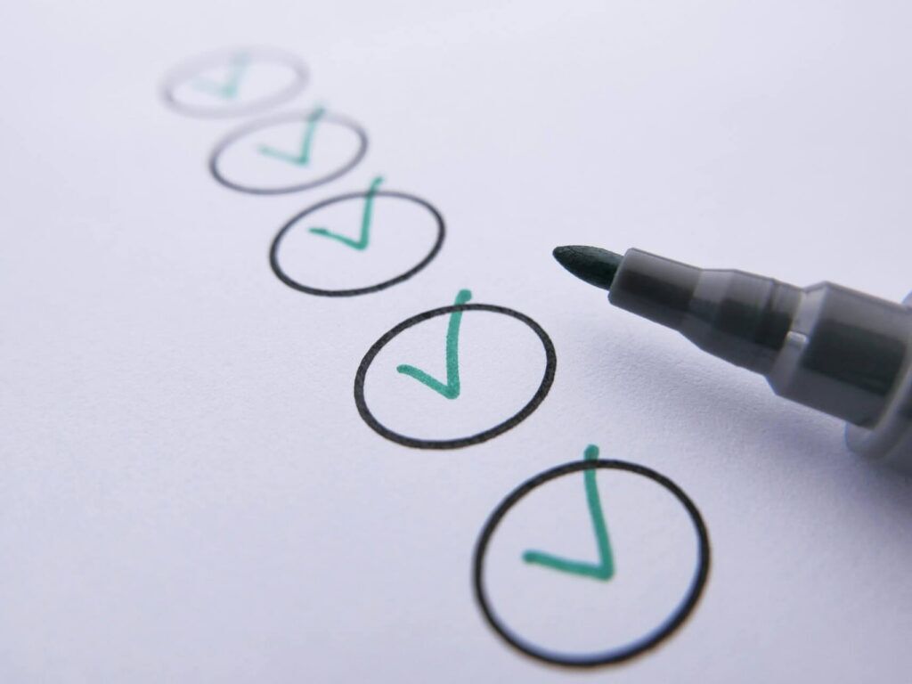 Pen and paper with checkmarks