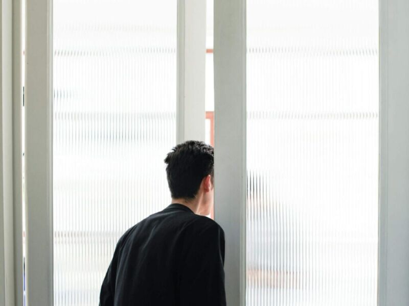 Man looking out door